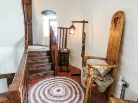 A landing area with a wooden chair and small table at The Old Cornmill in Cemaes Bay