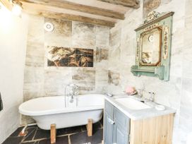 A bathroom with a bathtub and sink at The Old Cornmill in Cemaes Bay