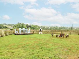 A garden with seating and a grill at The Old Cornmill in Cemaes Bay