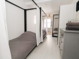 A bedroom with two beds and a cabinet at The Beach Condo in Weymouth