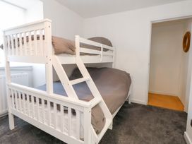 A bedroom with a bunk bed in The Beach Condo in Weymouth