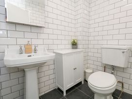 A bathroom with a sink and toilet at The Beach Condo in Weymouth