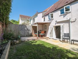 A garden with a table and chairs at Old Farm Cottage in Warminster