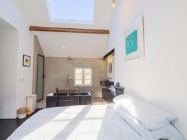A bathroom with a bathtub and sink at 2 Bredy Cottages in Burton Bradstock