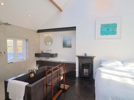 A bathroom with a bathtub and sink at 2 Bredy Cottages in Burton Bradstock