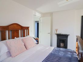 A bedroom with a bed and fireplace at 2 Bredy Cottages in Burton Bradstock