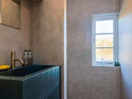 A bathroom with a sink and mirror at 2 Bredy Cottages in Burton Bradstock