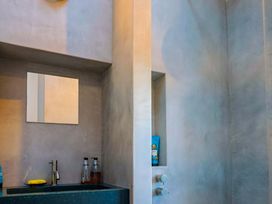 A sink and mirror in a bathroom at 2 Bredy Cottages in Burton Bradstock