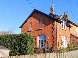 A house with a brick exterior and windows at 2 Bredy Cottages Burton Bradstock