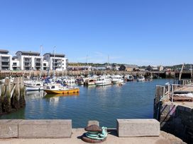A marina with boats and buildings at 2 Bredy Cottages, Burton Bradstock