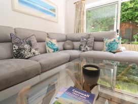 A living room with a sofa and a coffee table at Jaluna in Carbis Bay