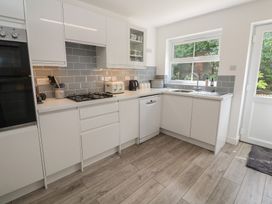 A kitchen with modern cabinets and appliances at Jaluna in Carbis Bay