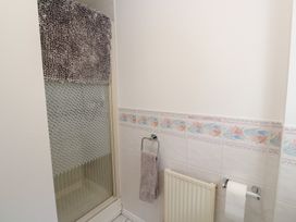 A bathroom with a shower and towels at Jaluna in Carbis Bay