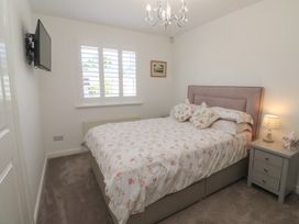 A bedroom with a bed and a television at Jaluna in Carbis Bay