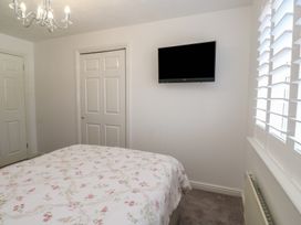 A bedroom with a bed and television at Jaluna in Carbis Bay