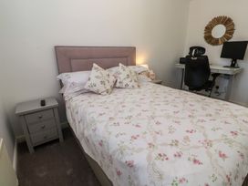 A bedroom with a bed and desk at Jaluna in Carbis Bay