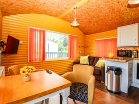 A living room with furniture and kitchen unit at Ava Lodge in West Mains near Haggerston