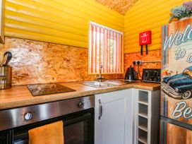 A kitchen with a sink, stove, and refrigerator at Ava Lodge, West Mains near Haggerston