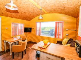 A kitchen with a table and chairs at Ava Lodge near Haggerston