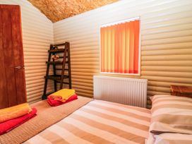 A bedroom with a bed and shelf at Ava Lodge West Mains near Haggerston