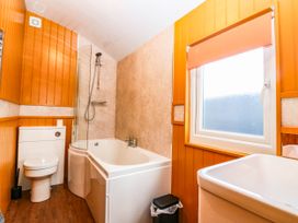 A bathroom with a bathtub and shower at Ava Lodge in West Mains near Haggerston