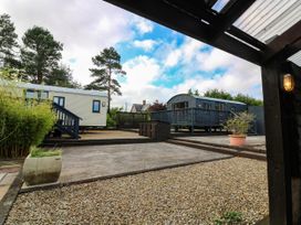 An outdoor area with mobile homes and a gravel path at Ava Lodge in West Mains near Haggerston