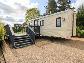 A mobile home with a deck and stairs at Masons Hut West Mains near Haggerston