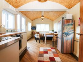 A kitchen with a table and chairs at Masons Hut near Haggerston