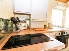 A kitchen with an induction hob and a kettle at Masons Hut West Mains near Haggerston