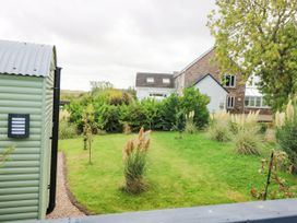 A garden with a shed and plants at Masons Hut in West Mains near Haggerston