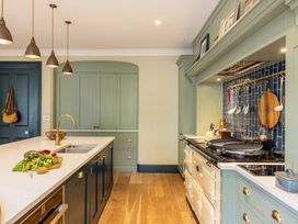 A kitchen with an island and cooking range at The Old Vicarage in Merriott