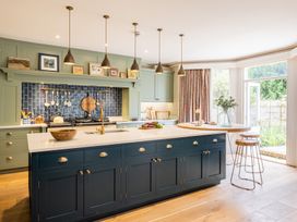 A kitchen with an island and cabinets at The Old Vicarage in Merriott