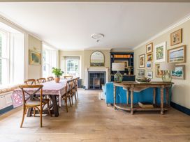 A dining room with a table and chairs at The Old Vicarage in Merriott