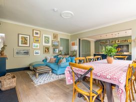 A living room with a sofa and dining table at The Old Vicarage in Merriott