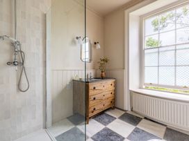 A bathroom with a shower and vanity at The Old Vicarage in Merriott