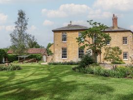 An outdoor view of a house with a garden at The Old Vicarage in Merriott