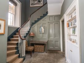 A hallway with stairs and a mirror at The Old Vicarage in Merriott