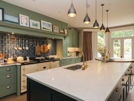 A kitchen with a central island and cooking stove at The Old Vicarage in Merriott