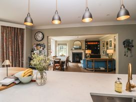 A kitchen with a dining area and a sofa at The Old Vicarage in Merriott