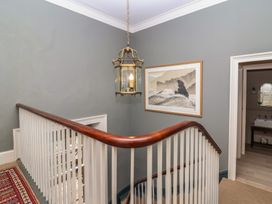 A staircase with a lantern and framed artwork at The Old Vicarage in Merriott
