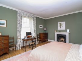 A bedroom with a bed and furniture at The Old Vicarage in Merriott