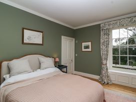 A bedroom with a bed and window at The Old Vicarage in Merriott