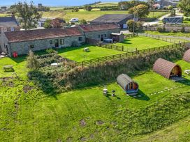 An outdoor view of a property with cabins and picnic areas at Deer Pod Staintondale near Burniston