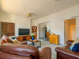 A living room with a television and coffee table at Flat 56 Newton Road Abertawe