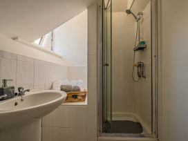 A bathroom with a shower and sink at Flat 56 Newton Road Abertawe