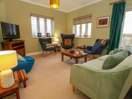 A living room with a television and coffee table at Corner Cottage in Preston