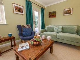A living room with a sofa and armchair at Corner Cottage Preston
