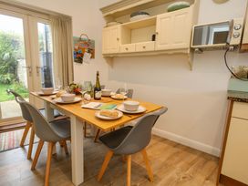 A kitchen with a dining table set for a meal at Corner Cottage Preston