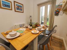 A dining room with a table set for a meal at Corner Cottage in Preston
