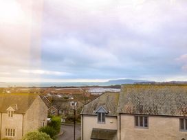 A view of houses and the ocean at Corner Cottage in Preston